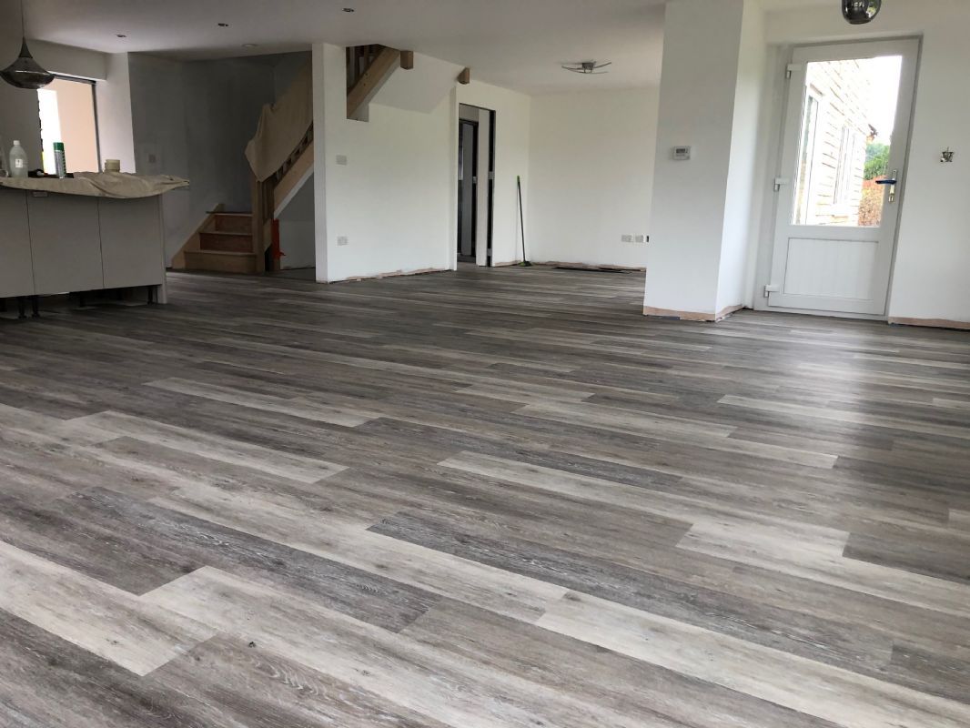 Grey plank luxury vinyl Shaun fitted through an open-plan kitchen and living space