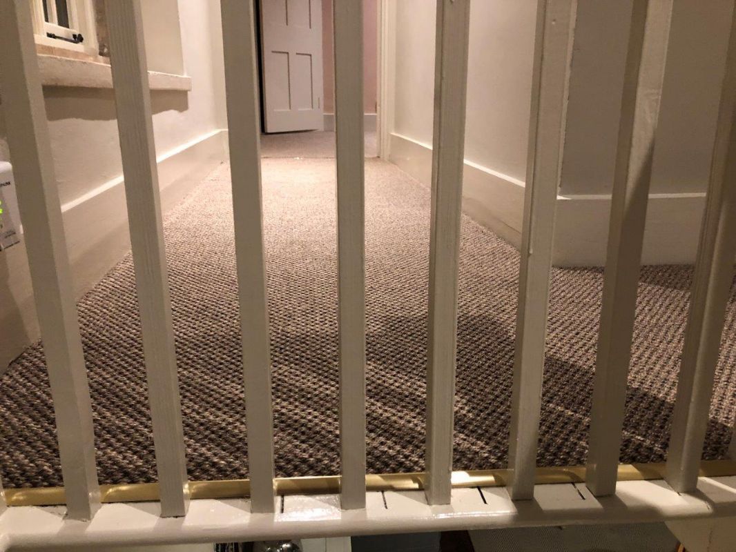 Natural-weave carpet across a landing in a Dursley home