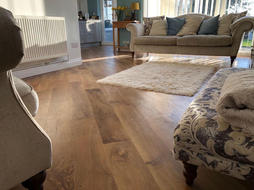 Oak-effect luxury vinyl planks through a sunlit living room