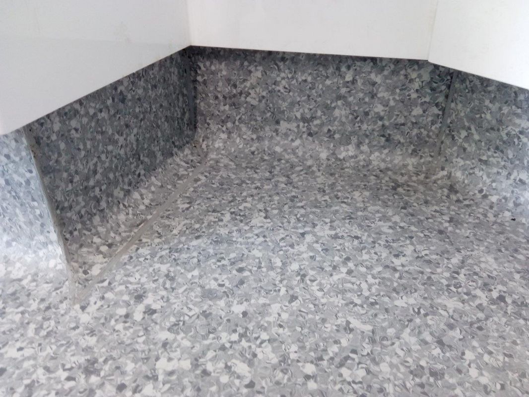Slip-resistant safety flooring Shaun fitted in a dental practice, coved up the walls
